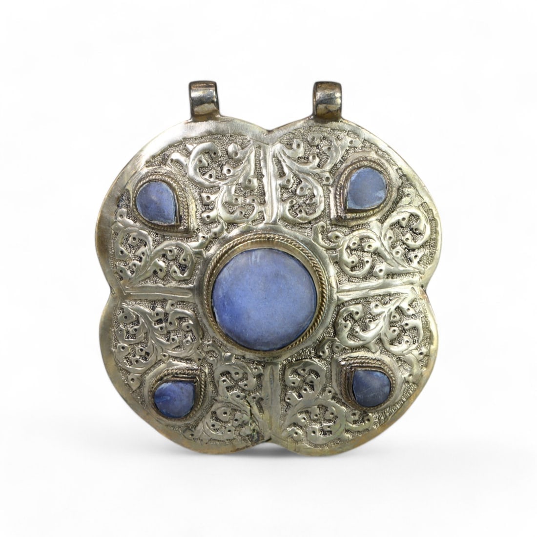 CENTRAL ASIAN: Silver "Floral Harmony" Pendant with Lapis Lazuli, 20th Century (117g, 7cm): This exquisite Central Asian silver pendant features a unique four-petal floral design, richly adorned with intricate engravings and set with five polished lapis lazuli stones. The central cabochon is
