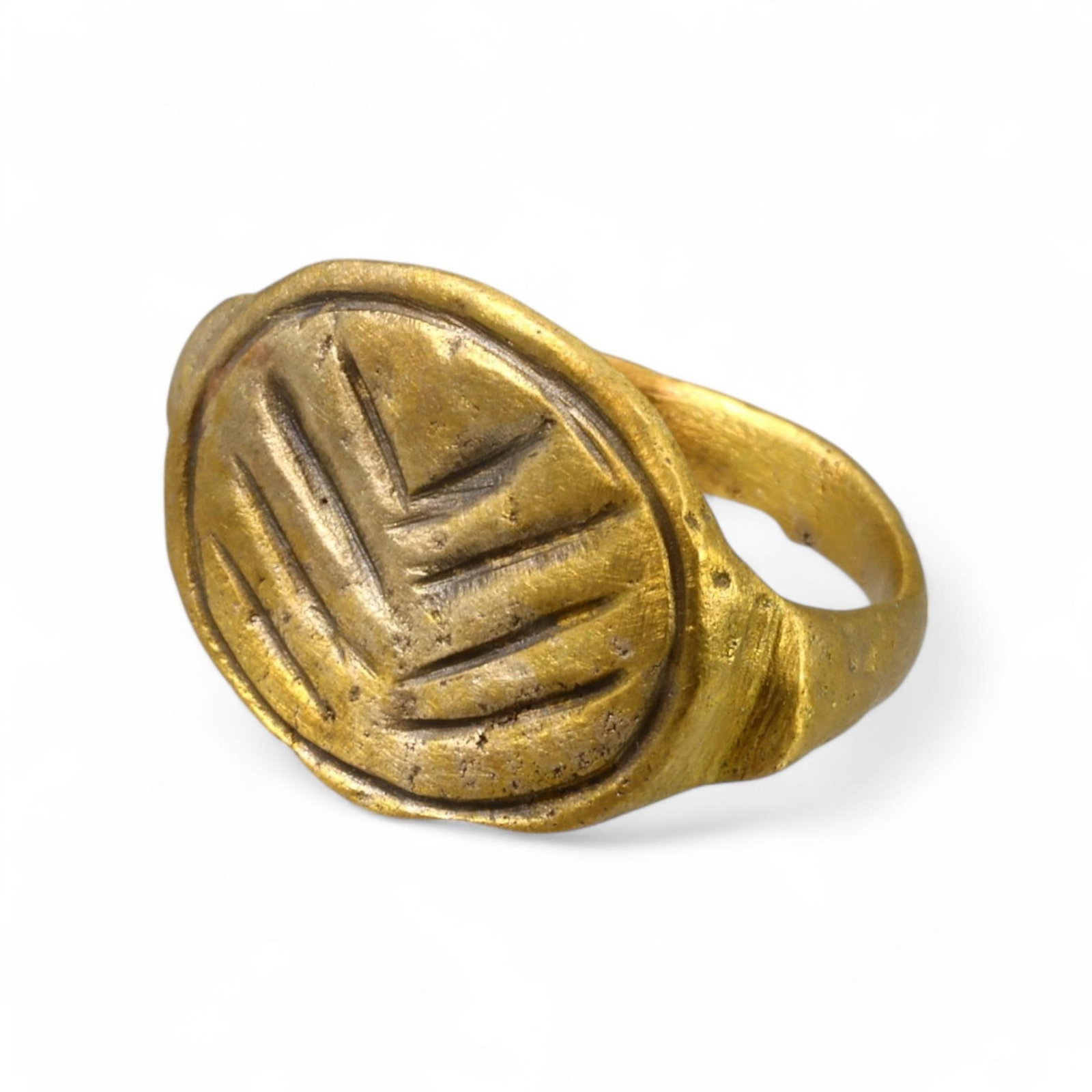 BYZANTINE ERA: Gold-Gilded Bronze Engraved Signet Ring, Circa 6th-9th Century CE (Size 7 US, 3g): This striking Byzantine-era gold-gilded bronze signet ring features an oval bezel engraved with a geometric leaf-like motif, symbolizing growth and renewal, themes frequently associated with Byzantine