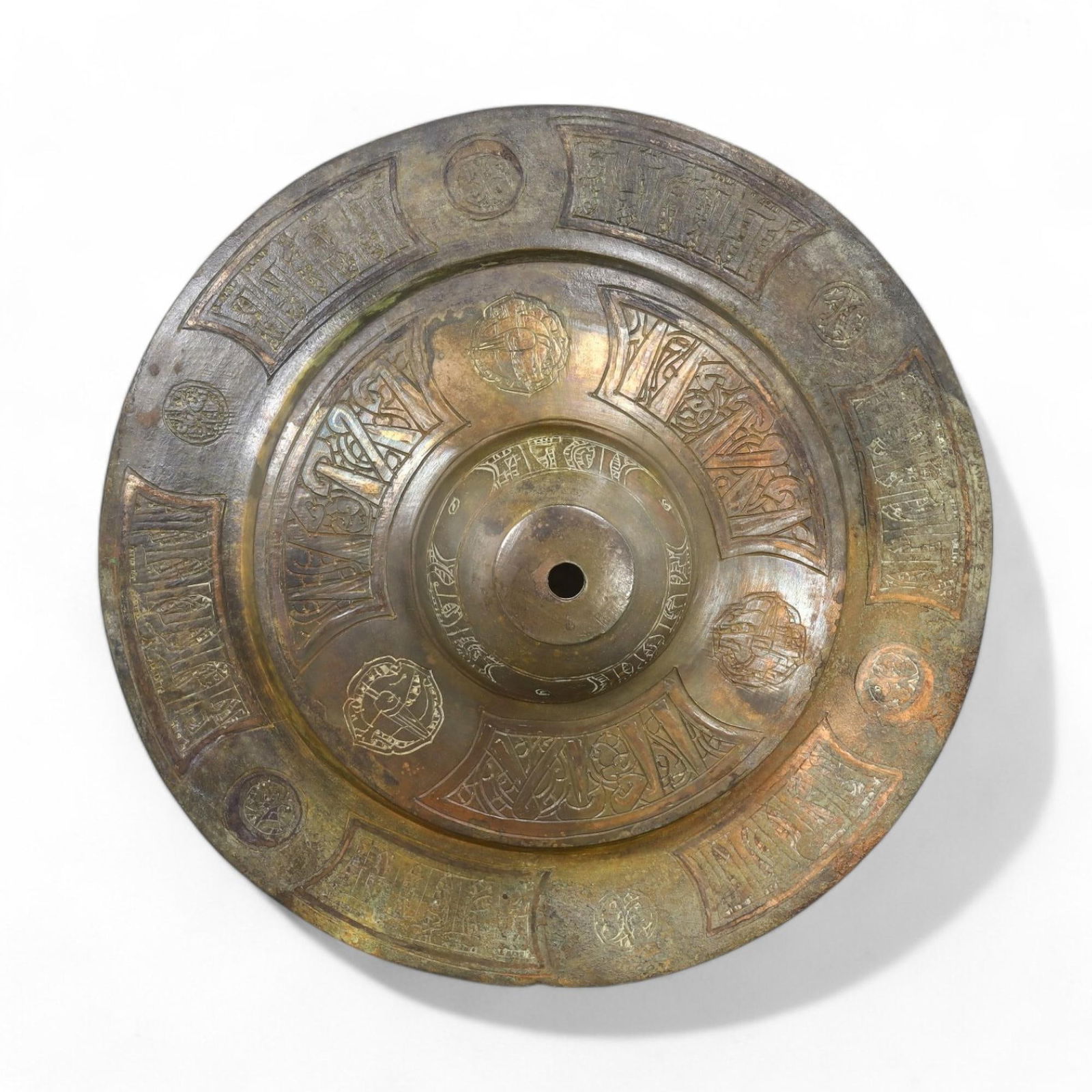 SARACEN ERA: Bronze Shield Boss with Engraved Motifs, 12th-14th Century CE (19 cm, 816 g): This Saracen-era bronze shield boss showcases intricate engraved motifs, including geometric patterns and stylized calligraphic inscriptions, highlighting the artistic and martial traditions of the Is