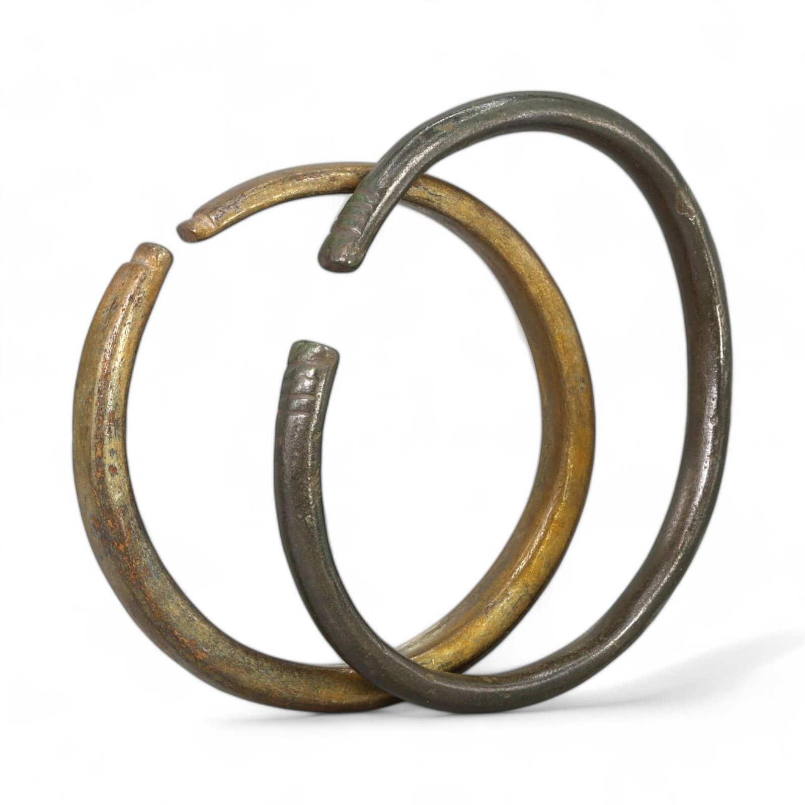 VIKING BRONZE ARM RINGS: 9th-11th Century CE (5-6 cm Diameter, 52g, Set of 2): This pair of Viking-era bronze arm rings showcases the minimalist yet functional design favored by Norse artisans. Each ring, weighing a total of 52g and measuring 5-6 cm in diameter, is crafted from 
