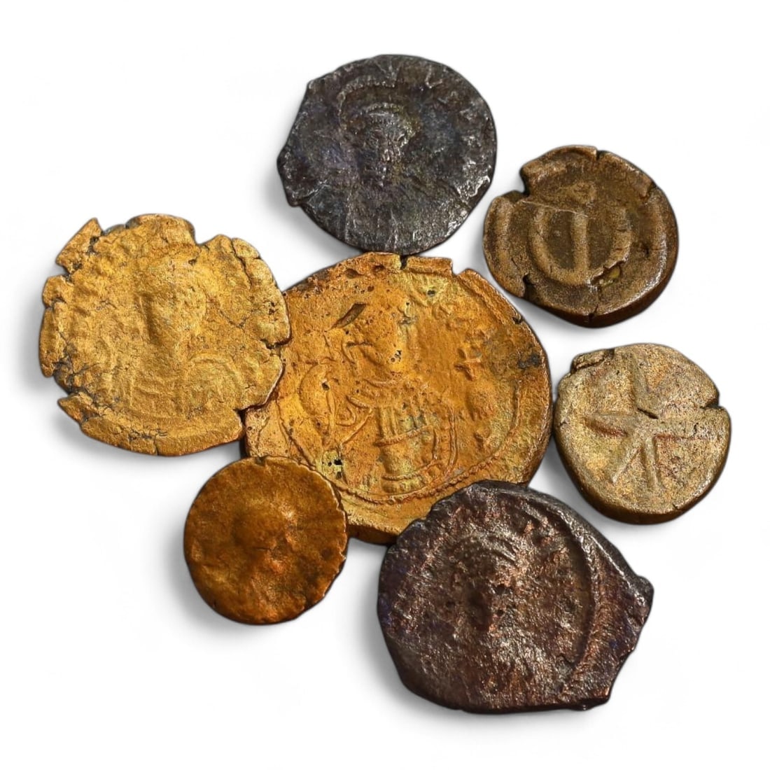 BYZANTINE EMPIRE: Lot of 7 Bronze and Copper Coinage, Circa 6th-11th Century CE (15g, 12-22mm): This collection of Byzantine coins, showcases the rich variety of bronze and copper coinage from the Byzantine Empire. Featuring imperial busts, Christian iconography, and legible inscriptions, these 