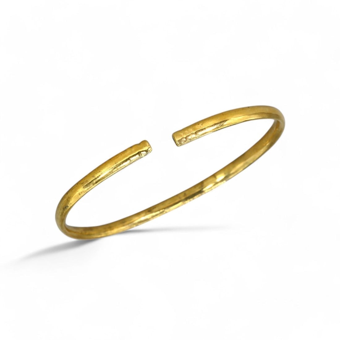 VIKING AGE: Gold-Gilt Armlet Bracelet, 7g, 5.5cm, 24k Gold Gilt: This elegant Viking armlet bracelet, weighing 7g with a diameter of 5.5cm, showcases a simple yet refined design in 24k gold gilt. The minimalistic open-ended style reflects the Viking tradition of co