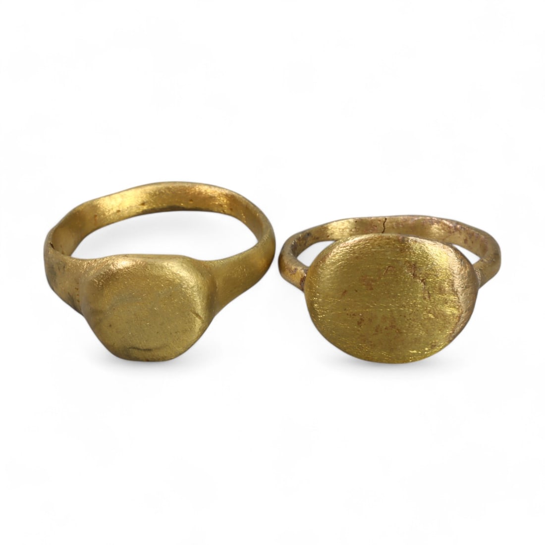 MEDIEVAL ERA: Gold-Gilt Signet Rings, 12th-14th Century CE (12g, Sizes 8 and 9.5 US, 2 Pieces): This pair of gold-gilt signet rings showcases the minimalist elegance of medieval craftsmanship. Each ring features a plain oval bezel, likely intended for personal or symbolic inscriptions that have 