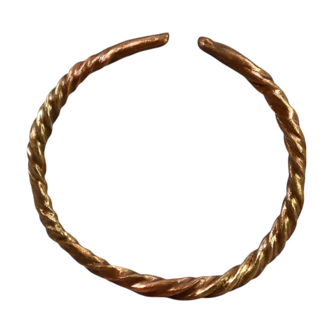 CELTIC ERA: Bronze "Twisted Proto-Money Ring," Circa 4th-1st Century BCE (8g, 4.5cm Diameter): This remarkable Celtic-era bronze twisted ring, also known as "proto-money," features an elegantly braided design characteristic of early Celtic craftsmanship. These rings were used both as ornamental