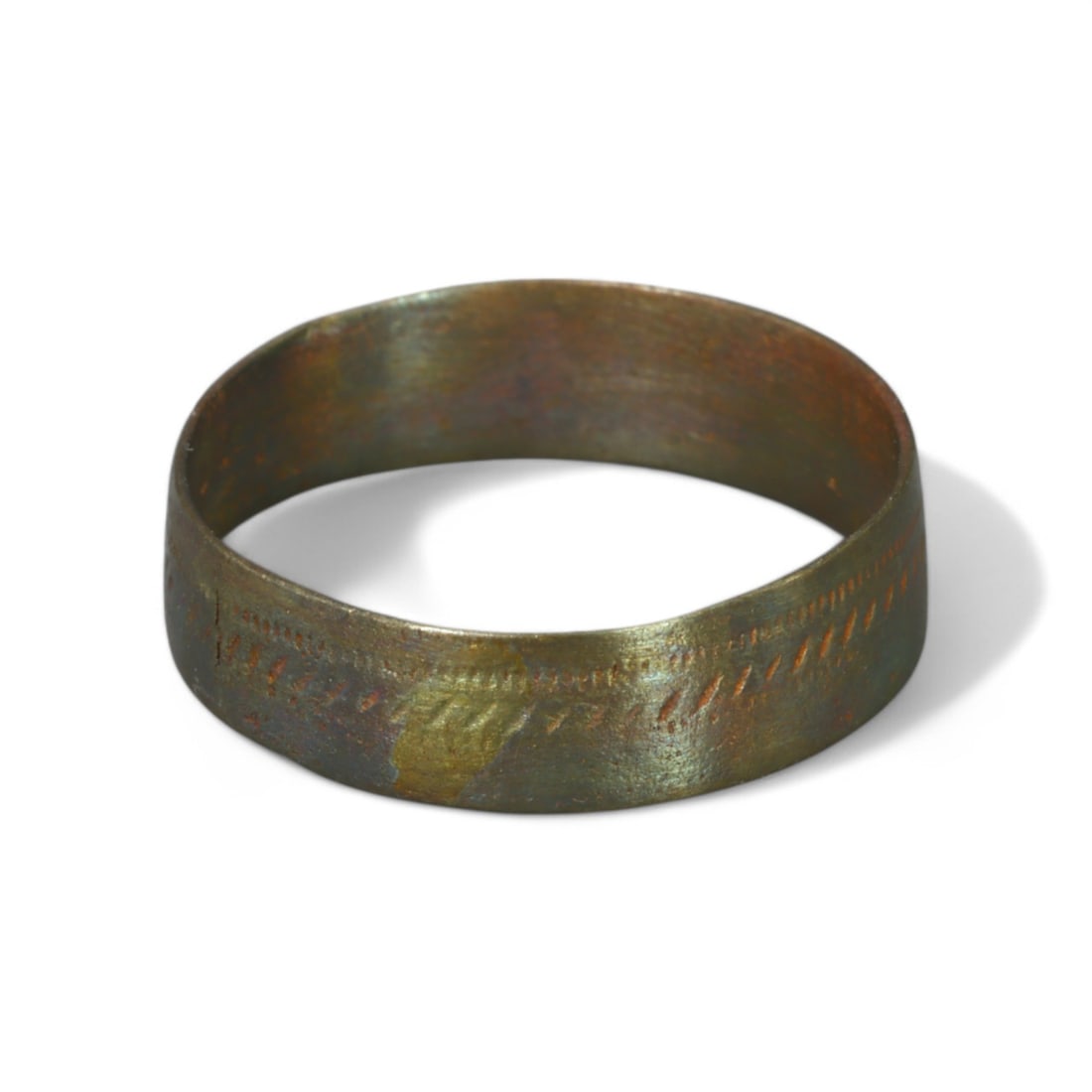 VIKING ERA: Bronze "Patterned Band" Ring, 9th-11th Century CE (Size 8 US, 1g): This finely crafted Viking-era bronze ring features a simple band adorned with subtle incised patterns, reflecting the Nordic preference for understated yet meaningful ornamentation. The lightweight d