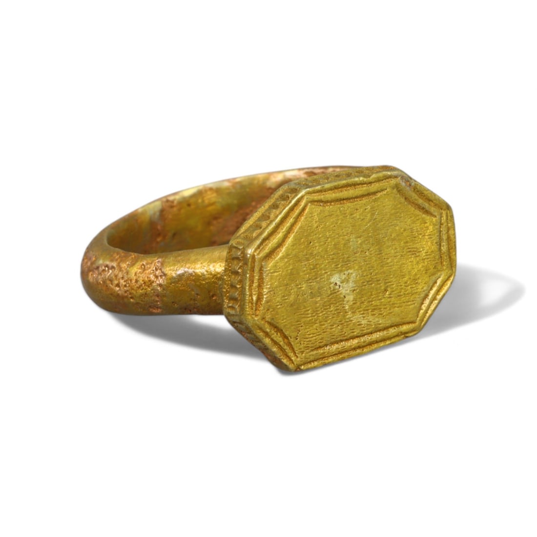 BYZANTINE ERA: Gold Gilt "Octagonal Signet Bezel" Ring, 6th-8th Century CE (Size 5 US, 8g): This elegant Byzantine-era ring, crafted in bronze and lavishly coated with a gleaming gold gilt, features a distinguished octagonal bezel bordered with fine linear engravings. The simplicity of its d