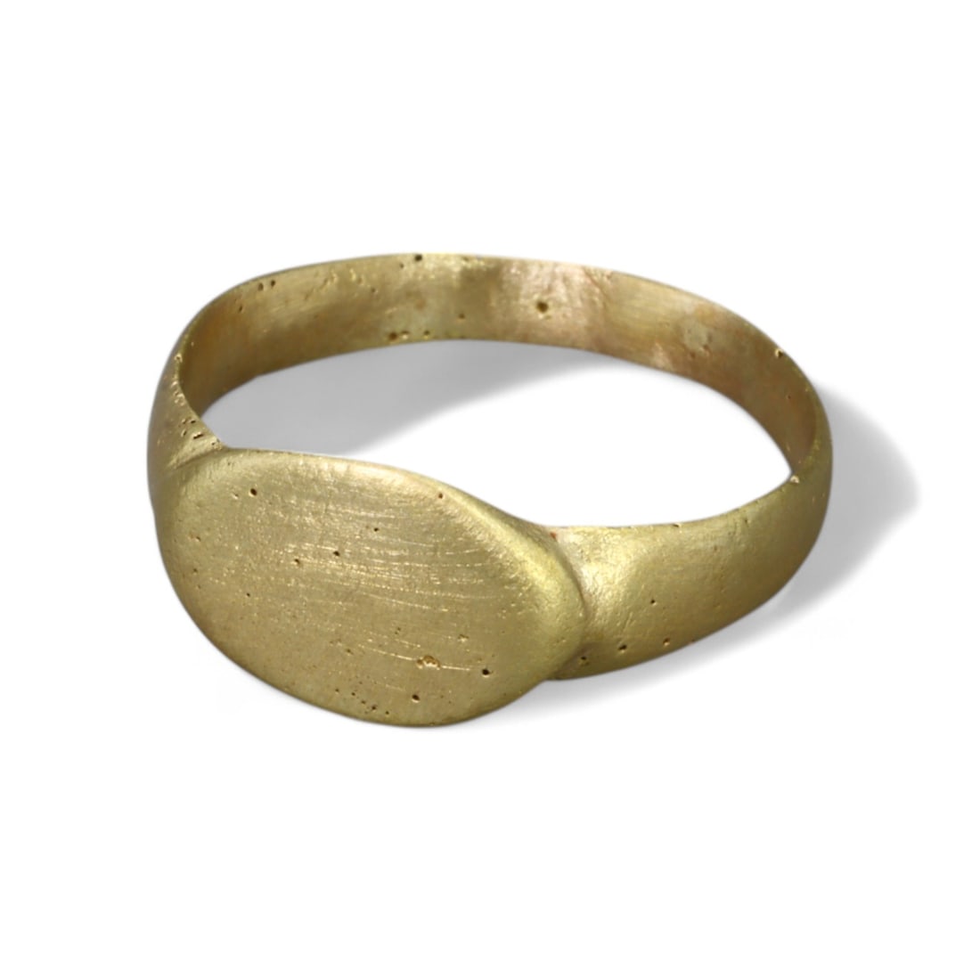 BYZANTINE ERA: Gold Gilt "Oval Bezel" Ring, 6th-8th Century CE (Size 5 US, 1.5g): This elegant Byzantine-era ring, crafted in bronze and gilded with a fine gold finish, features a smooth, oval bezel seamlessly integrated into its slender band. The minimalist design reflects the Byz