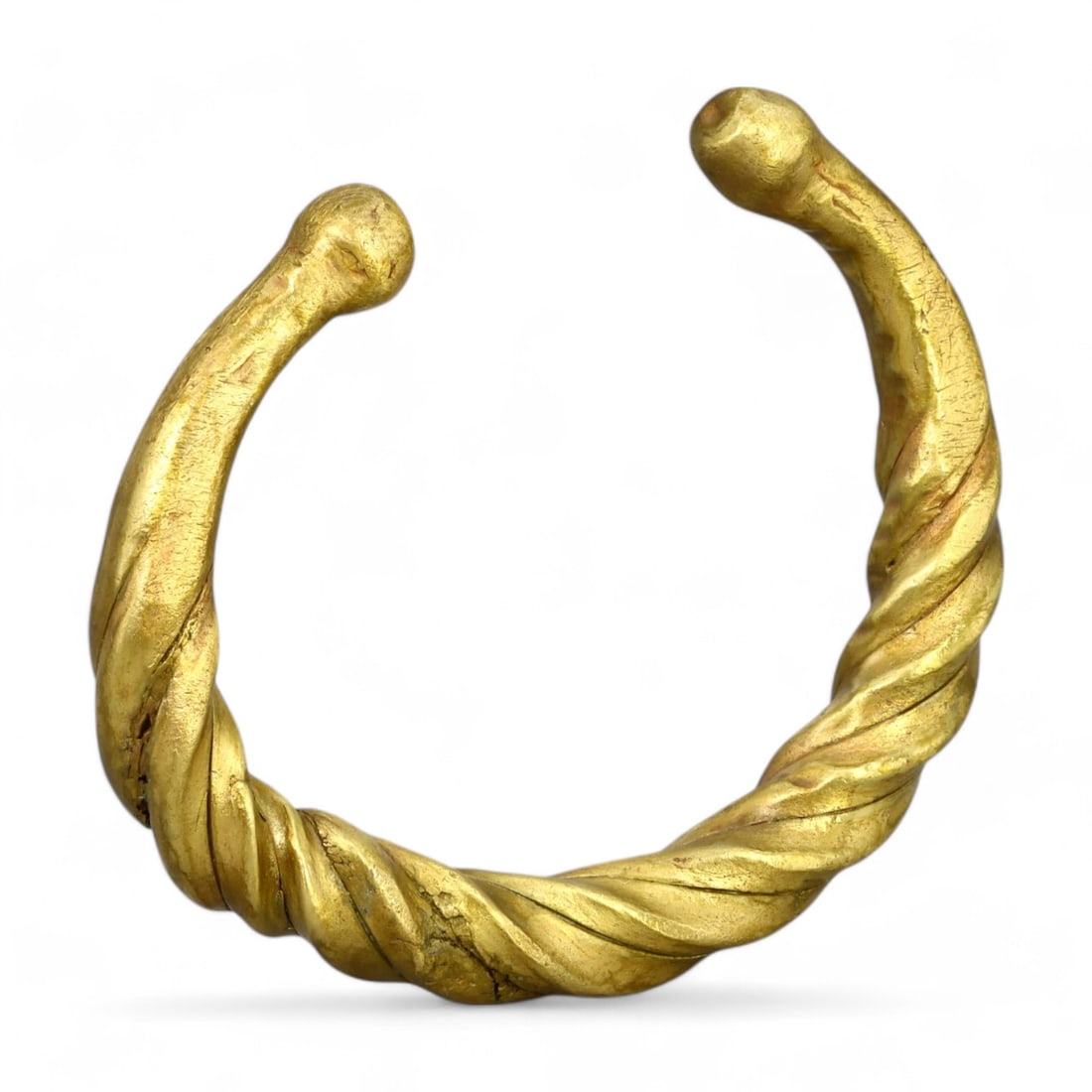 VIKING ERA: Gold-Gilt Twisted Bracelet, Circa 9th-11th Century CE (80g, 6cm): This striking Viking-era bracelet features a twisted design, symbolizing strength and craftsmanship. Gilded in gold, its robust construction and elegant contours reflect the dual purpose of Viking jew