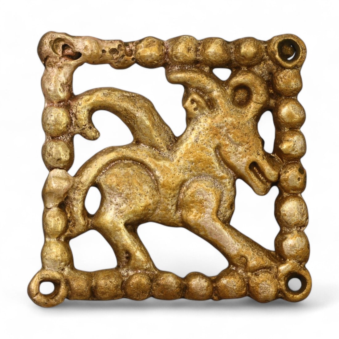 SIBERIAN: Gold-Gilt Belt Buckle with Goat Motif, 18th-19th Century CE (32g, 4x3.5cm): This charming Siberian gold-gilt belt buckle features a dynamic depiction of a goat, framed within a square beaded border. Weighing 32g and measuring 4x3.5 cm, the buckle exemplifies the craftsmanship