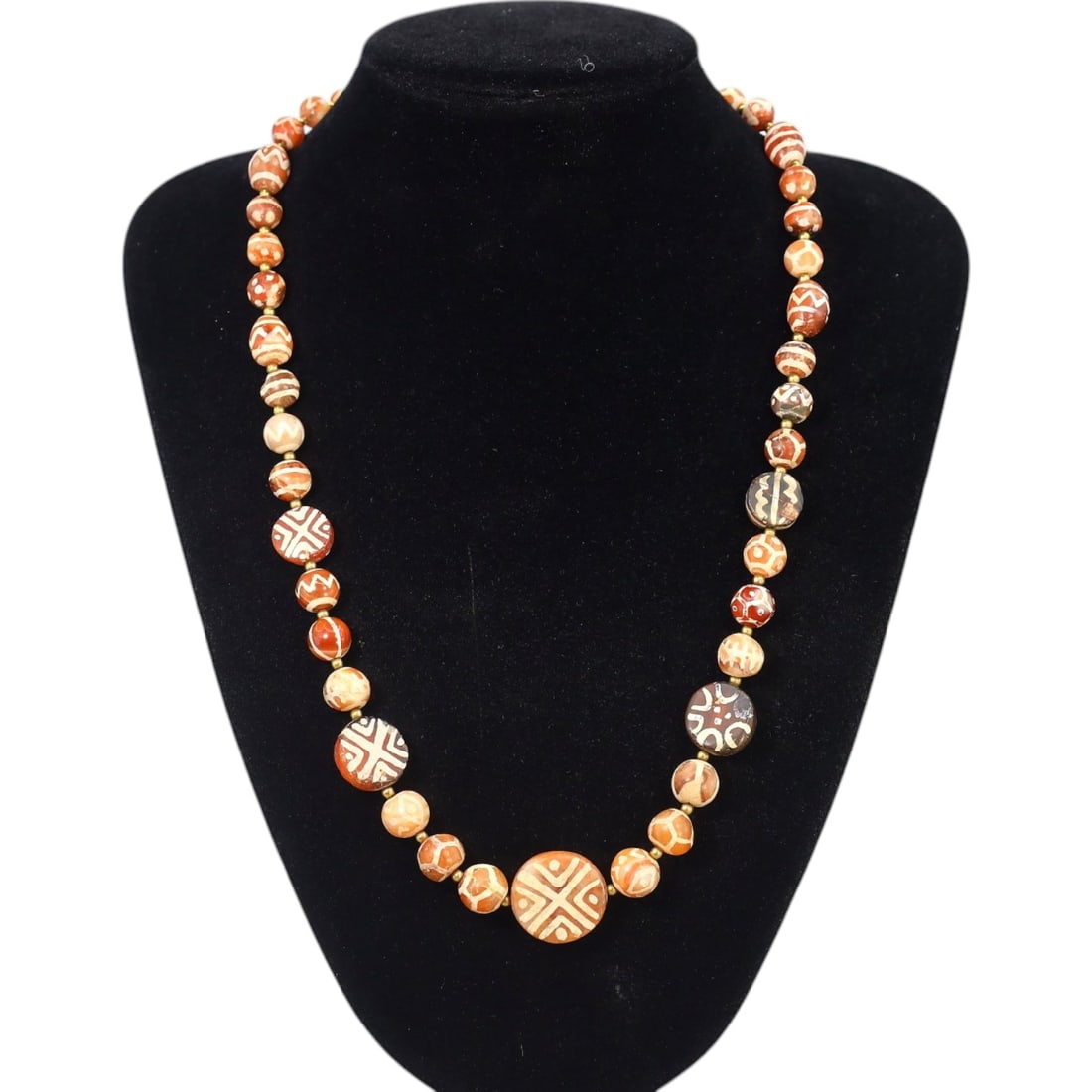 TIBETAN: Antique Etched Carnelian Dzi Beads Necklace, 19th-20th Century CE (54g, 50cm): This striking necklace features a strand of antique carnelian dzi beads, each intricately etched with traditional Tibetan motifs such as geometric patterns and eye designs, symbolizing protection and