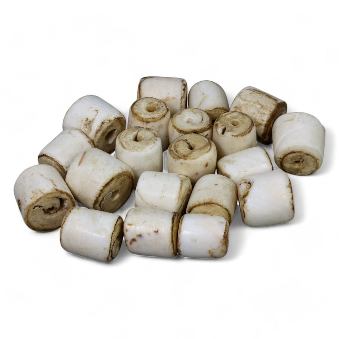 HIMALAYAN REGION: Carved Bone Cylinder Beads, 17th-19th Century CE (133g Total, 1x1cm Each): This collection of 1x1 cm cylindrical bone beads exemplifies the skill and resourcefulness of Himalayan artisans. Polished to a smooth finish with subtle natural markings, these beads collectively wei