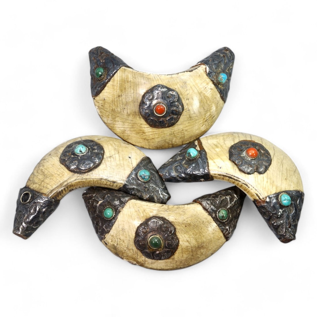 HIMALAYAN: Crescent-Shaped Carved Bone with Silver and Turquoise Inlays, 17th-19th CE (108g, 6x2cm): This stunning collection of crescent-shaped amulets, carved from bone, showcases exquisite silverwork adorned with turquoise and other gemstone inlays. Each amulet, measuring 6x2 cm, is intricately de