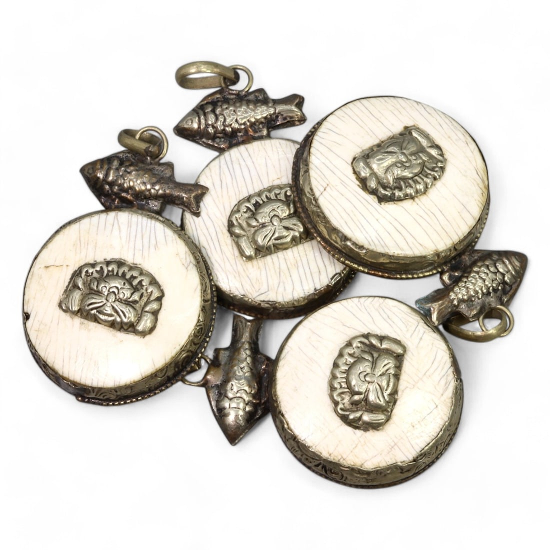 HIMALAYAN REGION:Carved Bone Amulets with Silver Fish and Mask Motifs, 17th-19th CE (60g, 4.5x3.5cm): This remarkable set of carved bone amulets hails from the Himalayan region, featuring finely detailed silver adornments. Each amulet showcases a central mask motif, symbolizing protection or warding o