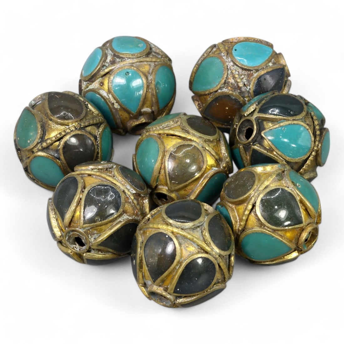 BYZANTINE ERA: Gilded Bronze Cloisonne Beads with Glass Inlays, 6th-8th Century CE (65g, 3x2cm Each): This exceptional group of Byzantine-era beads showcases intricate cloisonne craftsmanship with gilded bronze frames adorned with vibrant turquoise and dark glass inlays. The spherical design, measurin