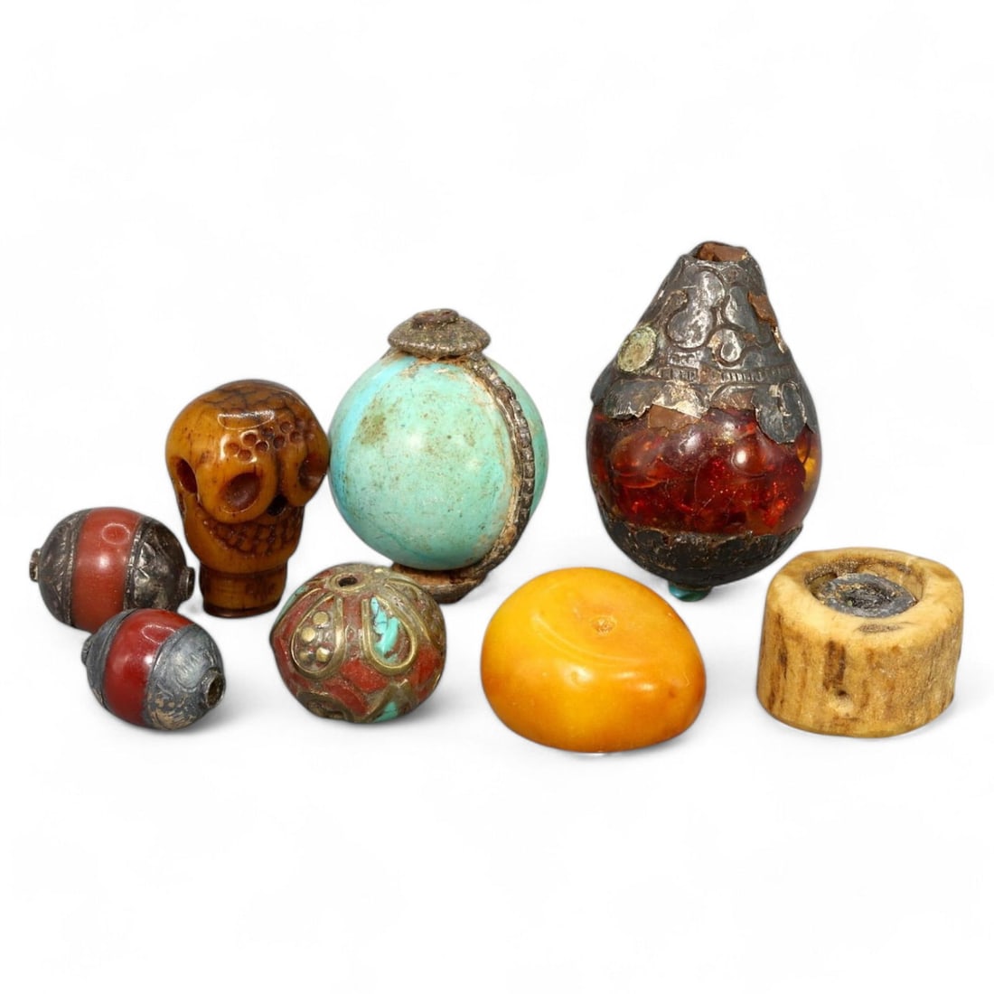TIBETAN MIXED MATERIAL BEADS: Set of 8, Circa 19th - 20th Century (1.4 - 3.4cm, 54g Total): This stunning set of eight Tibetan beads highlights the region's vibrant craftsmanship and spiritual symbolism. The beads are crafted from a variety of materials, including turquoise, coral, amber, si