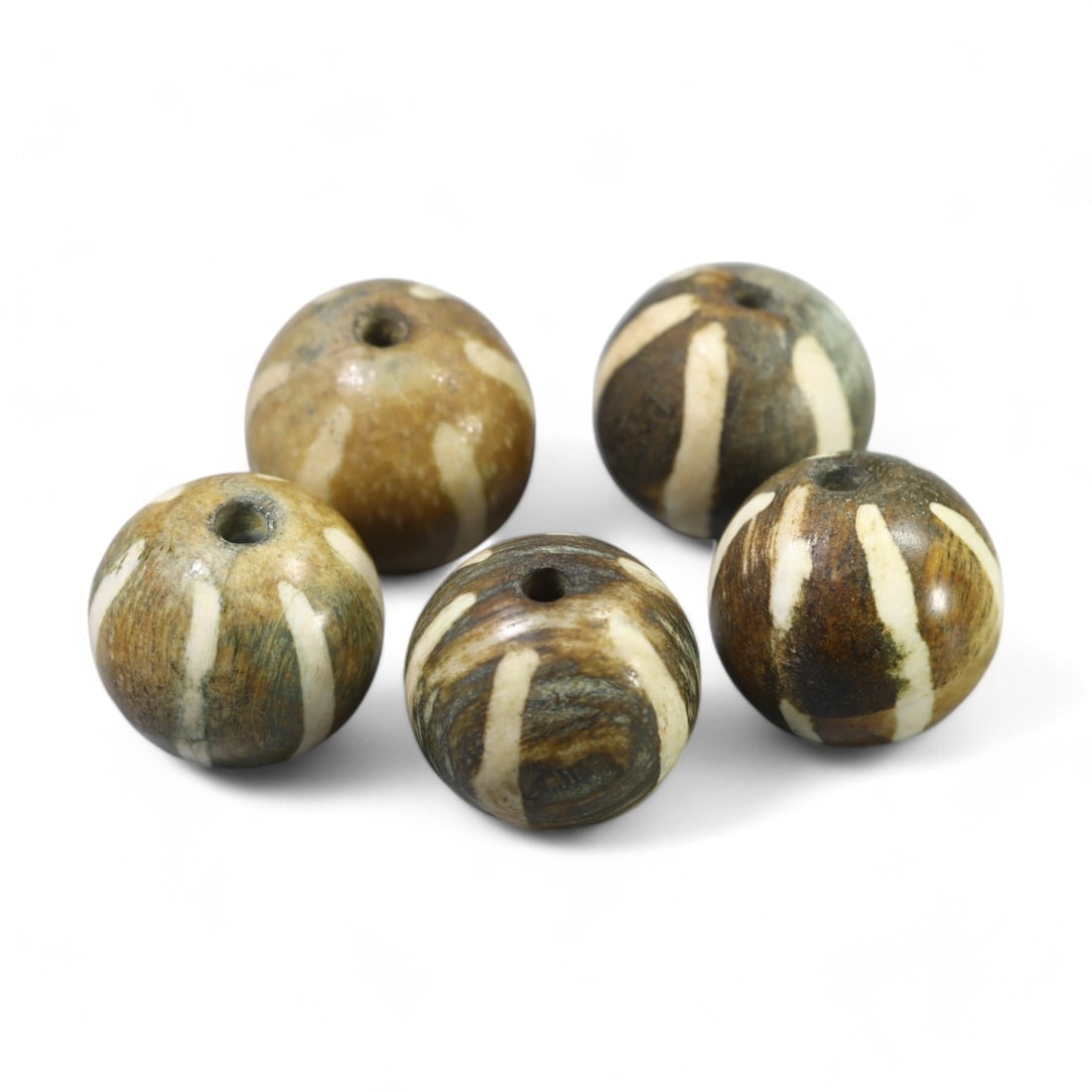 ANTIQUE TIBETAN: Pumtek Wood Beads with Radiating Motifs (24g, 17x16mm): This set of antique Tibetan Pumtek beads comprises five beautifully crafted fossilized wood beads adorned with radiating cream-colored motifs on a rich brown base. The subtle patina and natural textur