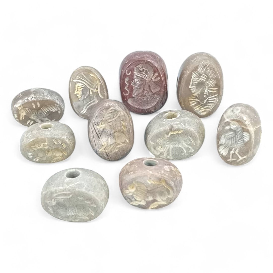 POST-MEDIEVAL PERSIAN STYLE: Lot of 10 Agate Intaglio Seal Beads, 19th-20th Century CE (133g,: This exquisite lot features agate seal beads, intricately carved in the Persian intaglio style, dating to the 19th-20th century CE. The beads, showcase finely detailed motifs such as profiles of figur