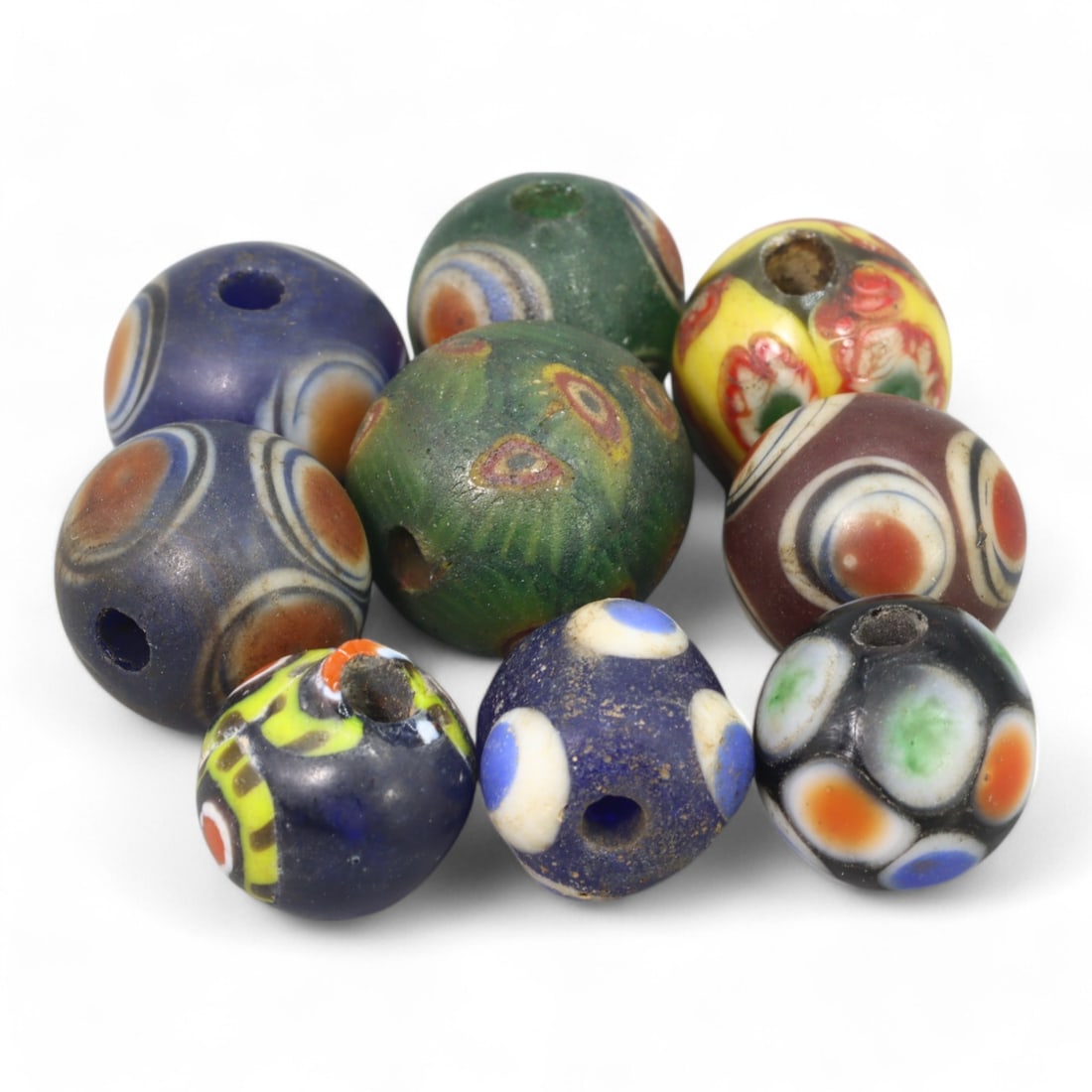 MILLEFIORI TRADE BEADS: Lot of Venetian Glass Eye Beads, 18g, 13-14mm: This captivating lot contains 18g of Venetian millefiori "eye" beads, each measuring 13-14mm. These beads are renowned for their vibrant colors and intricate eye-like patterns, created using the mille