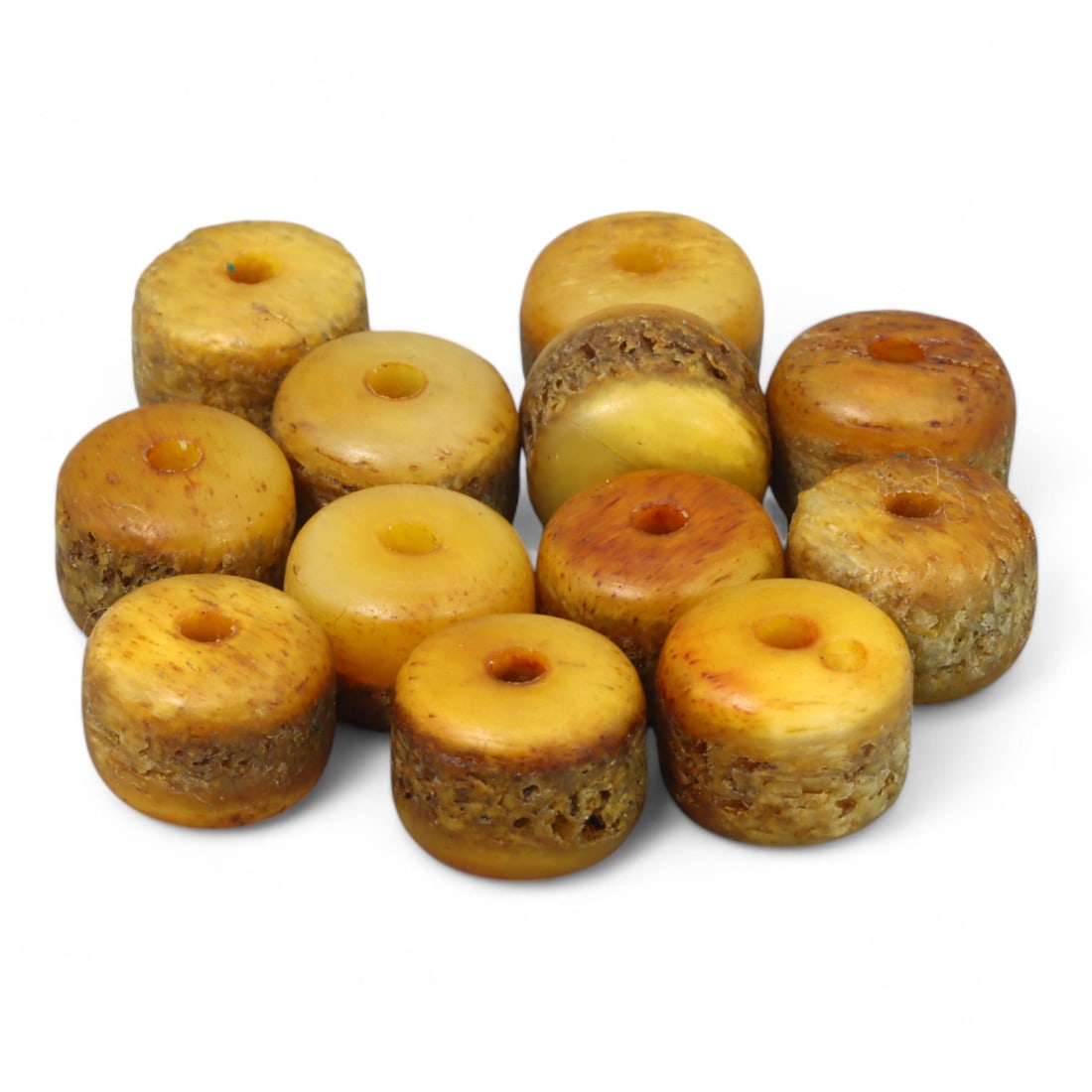 AFRICAN: Amber Disc Beads, (13g, 1cm, 12pcs): This set of African amber disc beads includes 12 pieces, collectively weighing 13 grams, with each bead measuring approximately 1cm in diameter. The warm golden and honey tones of the beads highlight 