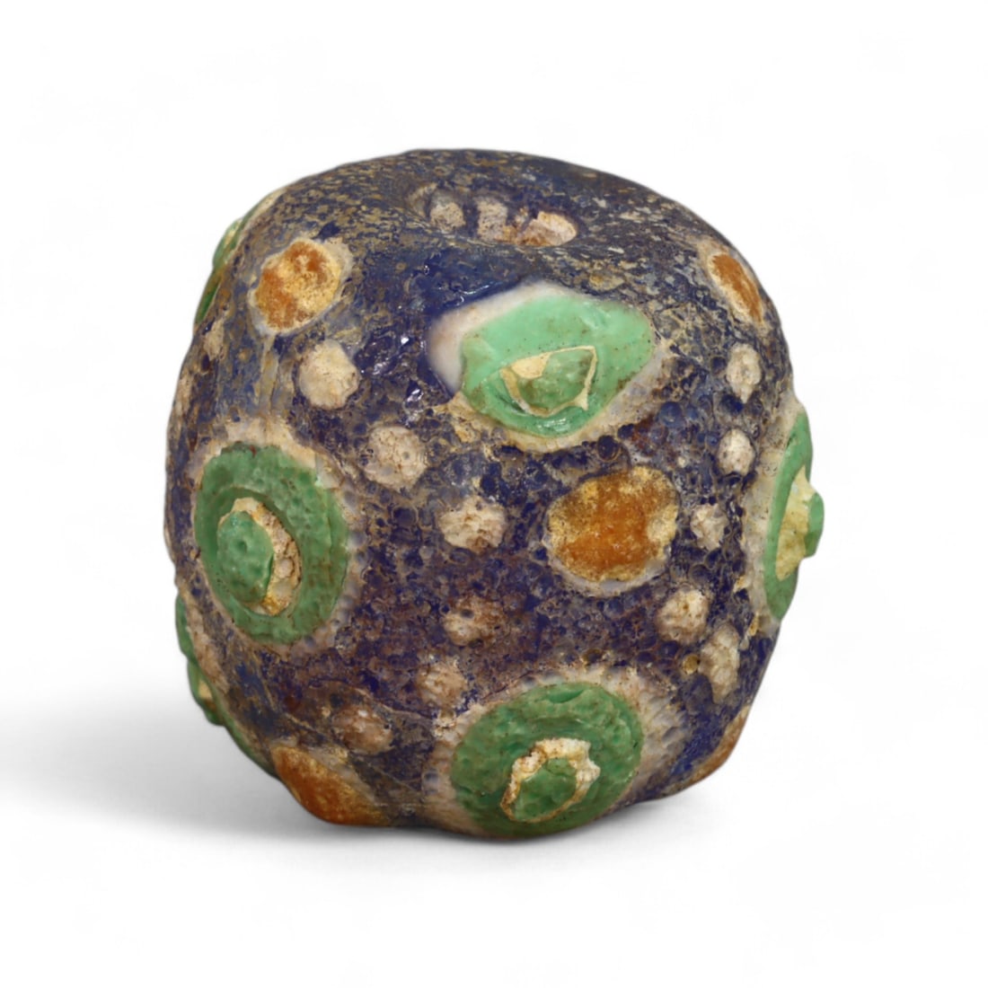 ROMAN ERA: Large Millefiori Glass Bead, 1st-3rd Century CE (19g, 21x20mm): This impressive Roman millefiori glass bead showcases the pinnacle of ancient glassmaking artistry. Featuring a deep cobalt blue base adorned with multicolored floral and geometric "eye" motifs in red