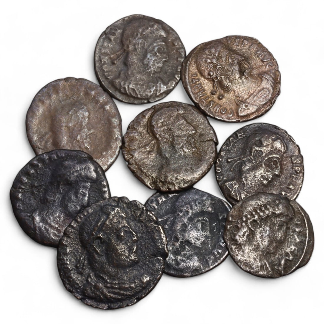 ROMAN EMPIRE: Lot of 9 AE Coins, Late Imperial Period, 13g, 15-18mm: This collection includes nine bronze coins from the late Roman Empire, the obverses feature various portraits of Roman emperors and notable figures, emphasizing the diversity of imperial iconography d