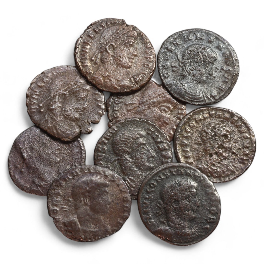 ROMAN EMPIRE: Lot of 9 AE Coins, Late Imperial Period, 18g, 17-18mm: This collection includes nine bronze coins from the late Roman Empire, ranging in diameter from 17 to 18mm. The obverses feature various portraits of Roman emperors and notable figures, emphasizing th