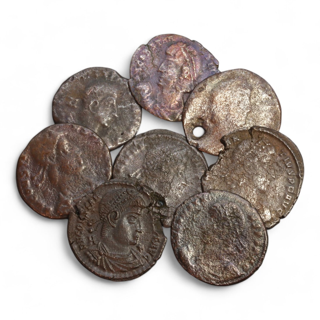 ROMAN EMPIRE: Lot of 8 AE Coins from the Constantinian Era, 4th Century CE (29g total, 20 - 24mm): This curated lot of eight bronze coins originates from the Constantinian era, a transformative period in the Roman Empire during the 4th century CE. Weighing a combined 29g and with diameters ranging 
