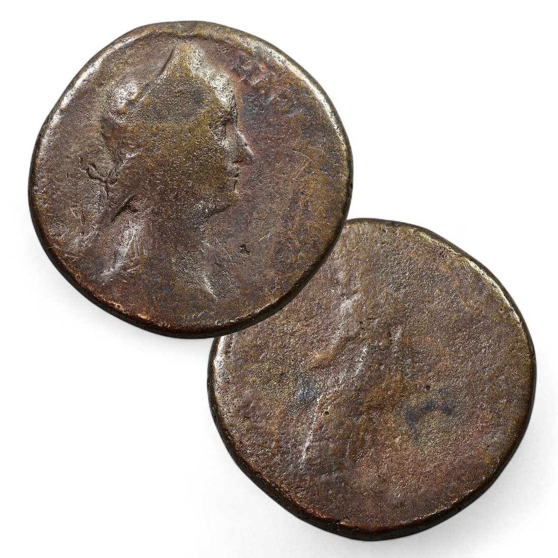 ROMAN EMPIRE: Bronze Coin of Plotina, Early 2nd Century CE (14g, 25mm): This bronze coin, weighing 14 grams and measuring 25mm in diameter, features Plotina, the esteemed wife of Emperor Trajan. The obverse displays a profile bust of Plotina, adorned with a diadem or veil