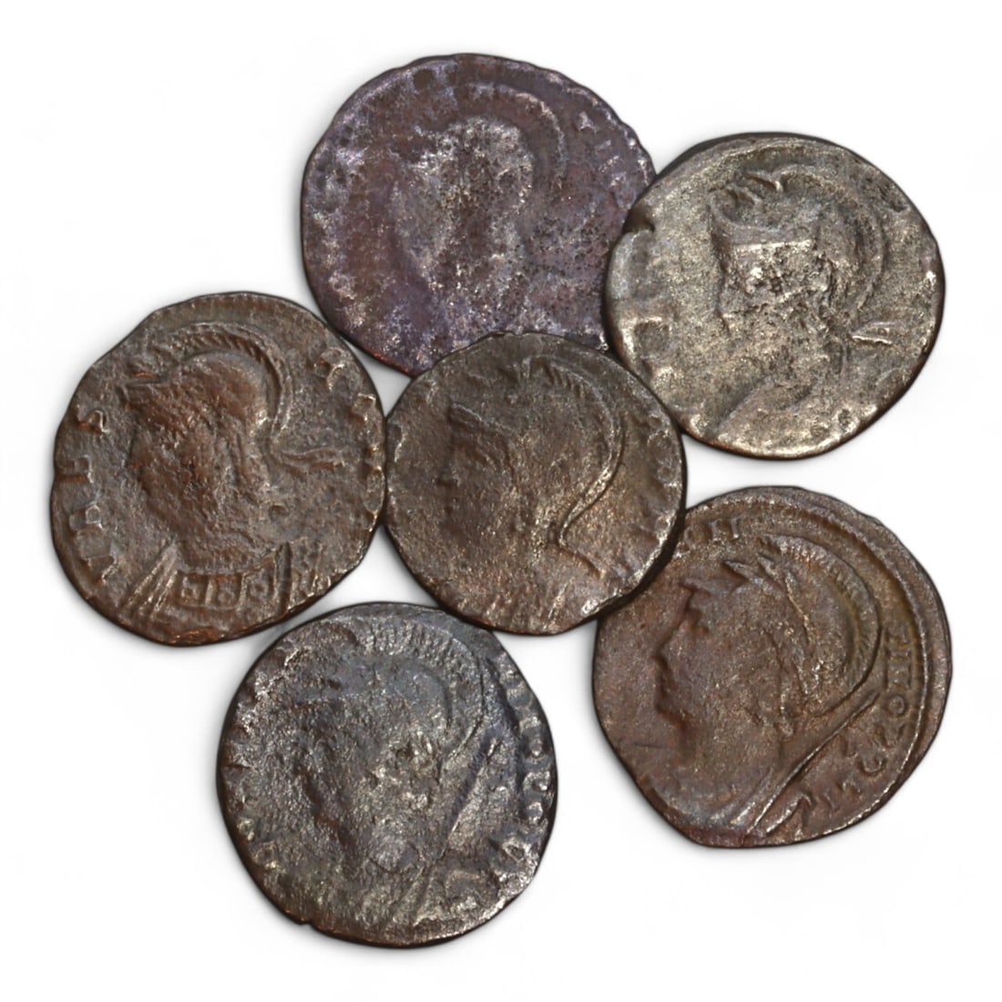 ROMAN EMPIRE: Lot of 6 Bronze Coins, Constantinian Dynasty, 4th Century CE (11g, 15-18mm): This curated lot includes 6 bronze coins from the Constantinian Dynasty, collectively weighing 11 grams, with diameters ranging from 15mm to 18mm. The obverse of each coin features a helmeted bust of 