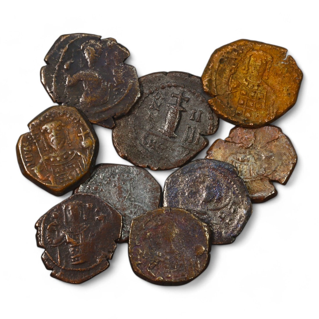 BYZANTINE EMPIRE: Nine Bronze Coins, Various Sizes, 9th-13th Century CE (18g Total, 15-21mm): This lot consists of 9 bronze coins from the Byzantine Empire, together weighing 18 grams and ranging in size from 15mm to 21mm. Each coin depicts motifs such as imperial portraits and crosses, emblem