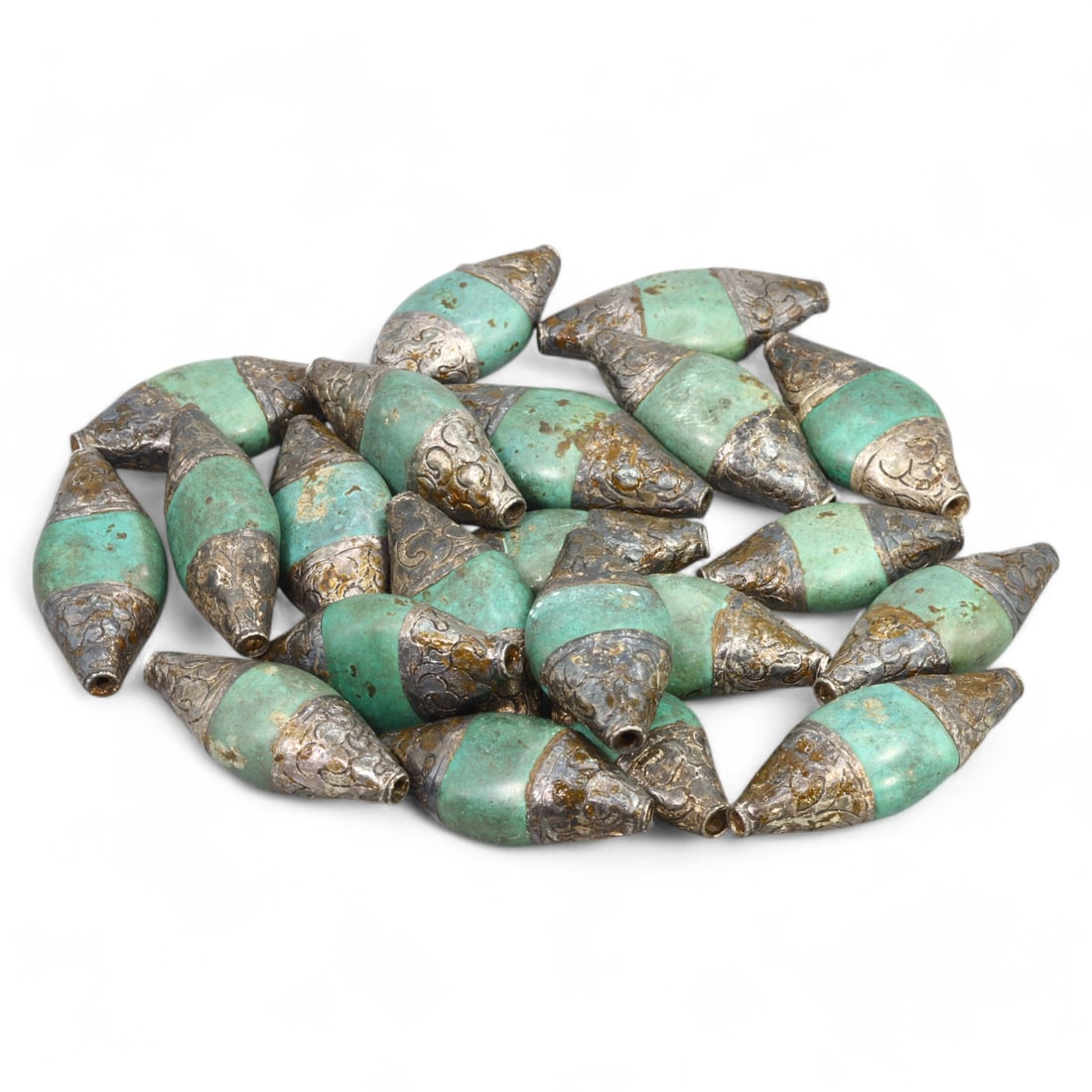 HIMALAYAN REGION: Silver and Green Glass Beads, Tibet / Nepal (219g, 4.5x2cm): This set of elegant beads from the Himalayan region, likely originating from Tibet or Nepal, features a striking combination of green glass and intricately patterned silver caps. Each bead is elongate