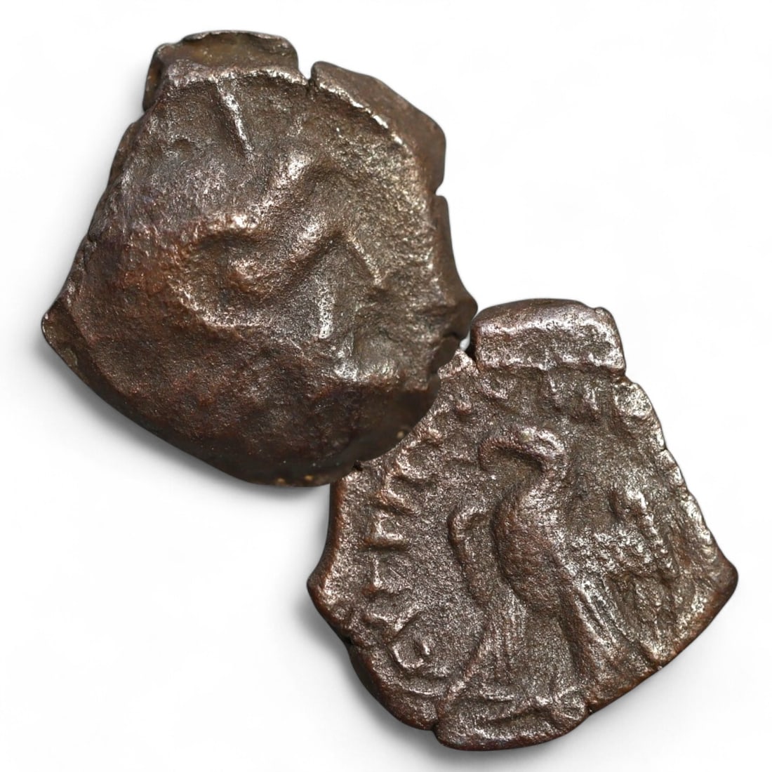 PTOLEMAIC KINGDOM: AE15 Bronze Coin (2g, 15mm): This small bronze coin from the Ptolemaic Kingdom features an obverse with a faint, worn design, likely the head of a ruler or deity, a hallmark of Hellenistic coinage. The reverse displays an eagle, 