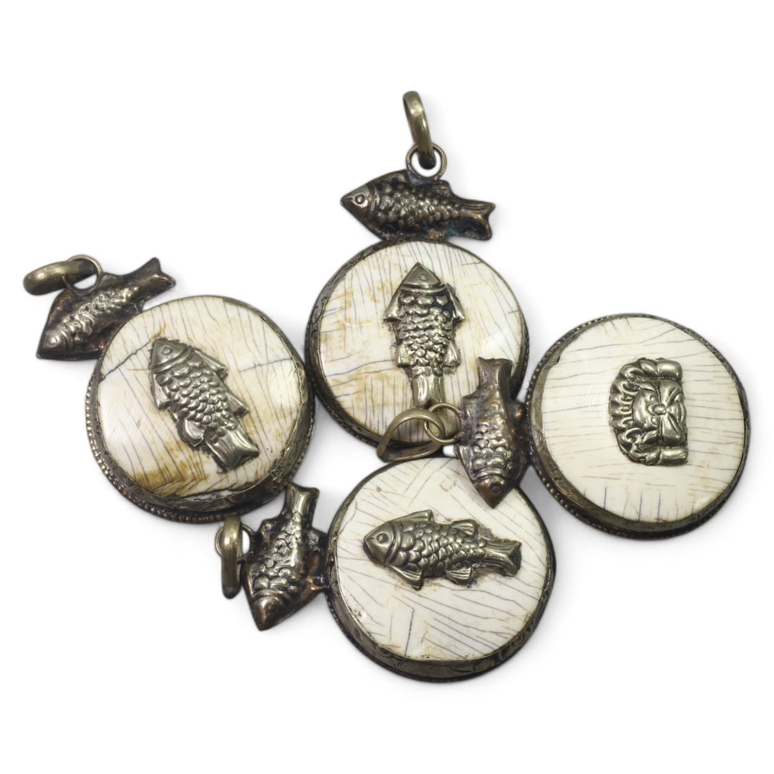 HIMALAYAN: Antique Carved Bone Amulets with Silver Fish Motifs (64g, 4.5cm): This remarkable set of carved bone amulets hails from the Himalayan region, featuring finely detailed silver adornments. Each amulet showcases a central mask motif, symbolizing protection or warding o