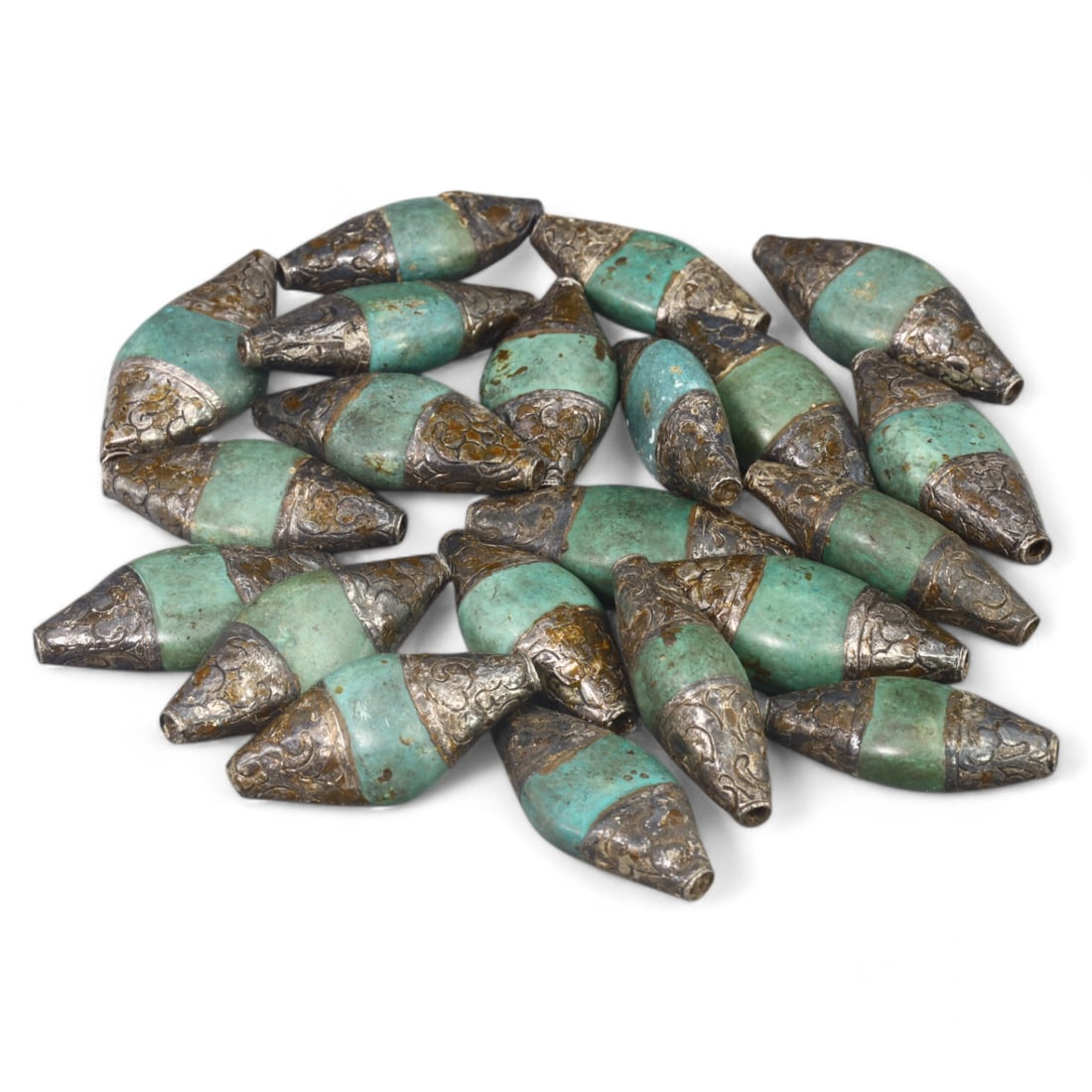 HIMALAYAN: Silver and Green Glass Beads, Tibet / Nepal (212g, 4.5x2cm): This set of elegant beads from the Himalayan region, likely originating from Tibet or Nepal, features a striking combination of green glass and intricately patterned silver caps. Each bead is elongate