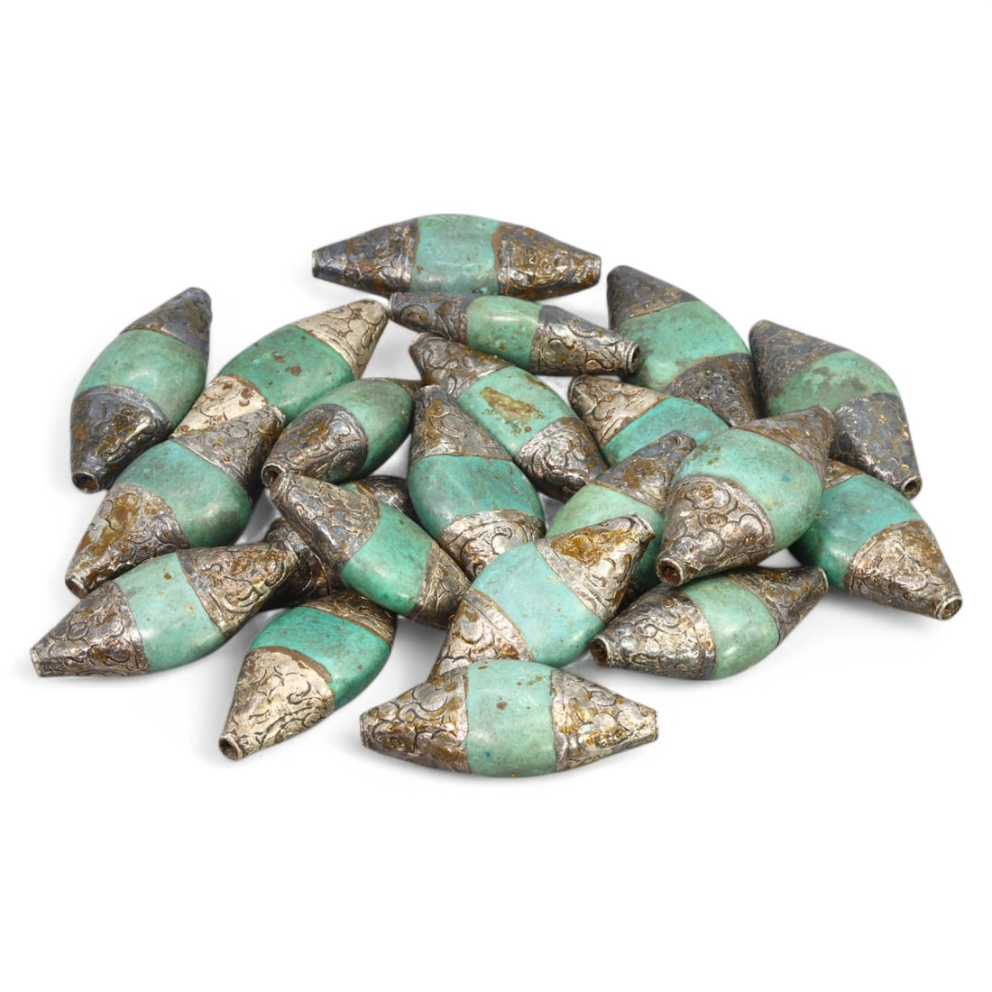 HIMALAYAN REGION: Silver and Green Glass Beads, Tibet / Nepal (221g, 4.5x2cm): This set of elegant beads from the Himalayan region, likely originating from Tibet or Nepal, features a striking combination of green glass and intricately patterned silver caps. Each bead is elongate