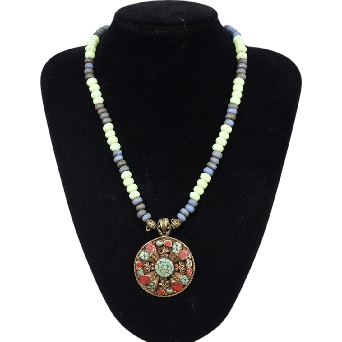 TIBETAN: Silver-Inlaid Turquoise and Coral Pendant Necklace, 19th-20th Century CE (64g, 48cm): This exquisite necklace features a central round pendant, intricately inlaid with vibrant turquoise and coral stones arranged in a floral motif and surrounded by delicate filigree patterns. Complement