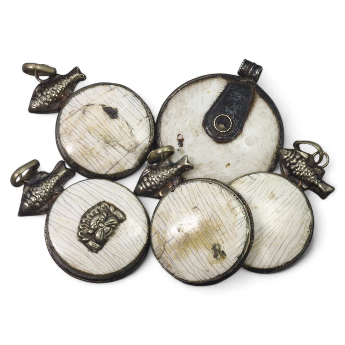 HIMALAYAN: Antique Carved Bone Amulets with Silver Fish Motifs (84g, 4.5cm): This remarkable set of carved bone amulets hails from the Himalayan region, featuring finely detailed silver adornments. Each amulet showcases a central mask motif, symbolizing protection or warding o