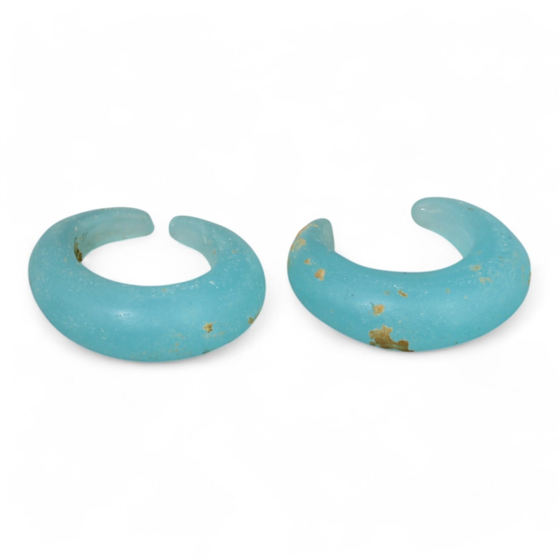 ANCIENT GLASS: Pair of Roman Blue Glass Bracelets, 1st-3rd Century CE (13g, 3cm each): This stunning pair of Roman glass bracelets, dating from the 1st-3rd century CE, exemplifies the vibrant artistry of ancient glassmakers. Each bracelet, crafted from translucent blue glass, is shaped 