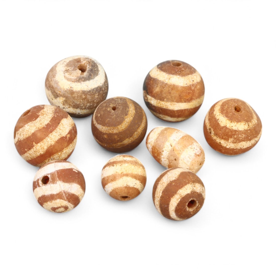 TIBETAN CULTURE: Antique Etched Carnelian Mala Beads (9g, 10-12mm): This set of antique Tibetan mala beads is crafted from etched carnelian, featuring intricate white zigzag and linear patterns that enhance their spiritual significance and aesthetic appeal. These bead