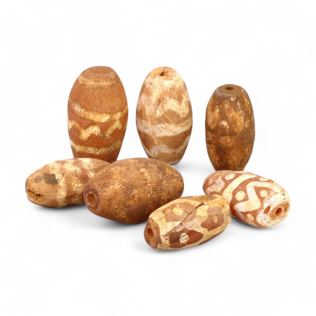 TIBETAN CULTURE: Antique Etched Carnelian Mala Beads (15g, 15-19mm): This set of antique Tibetan mala beads is crafted from etched carnelian, featuring intricate white zigzag and linear patterns that enhance their spiritual significance and aesthetic appeal. These bead