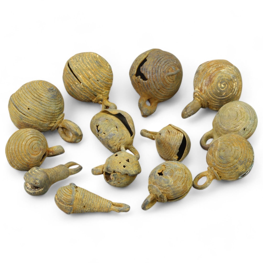 AFRICAN TRIBAL: Lot of West African Bronze Bells (120g, 1-2cm each): This collection of intricately crafted bronze bells originates from African tribal traditions, likely used as adornments, musical instruments, or ritual objects. Each bell features distinctive spiral