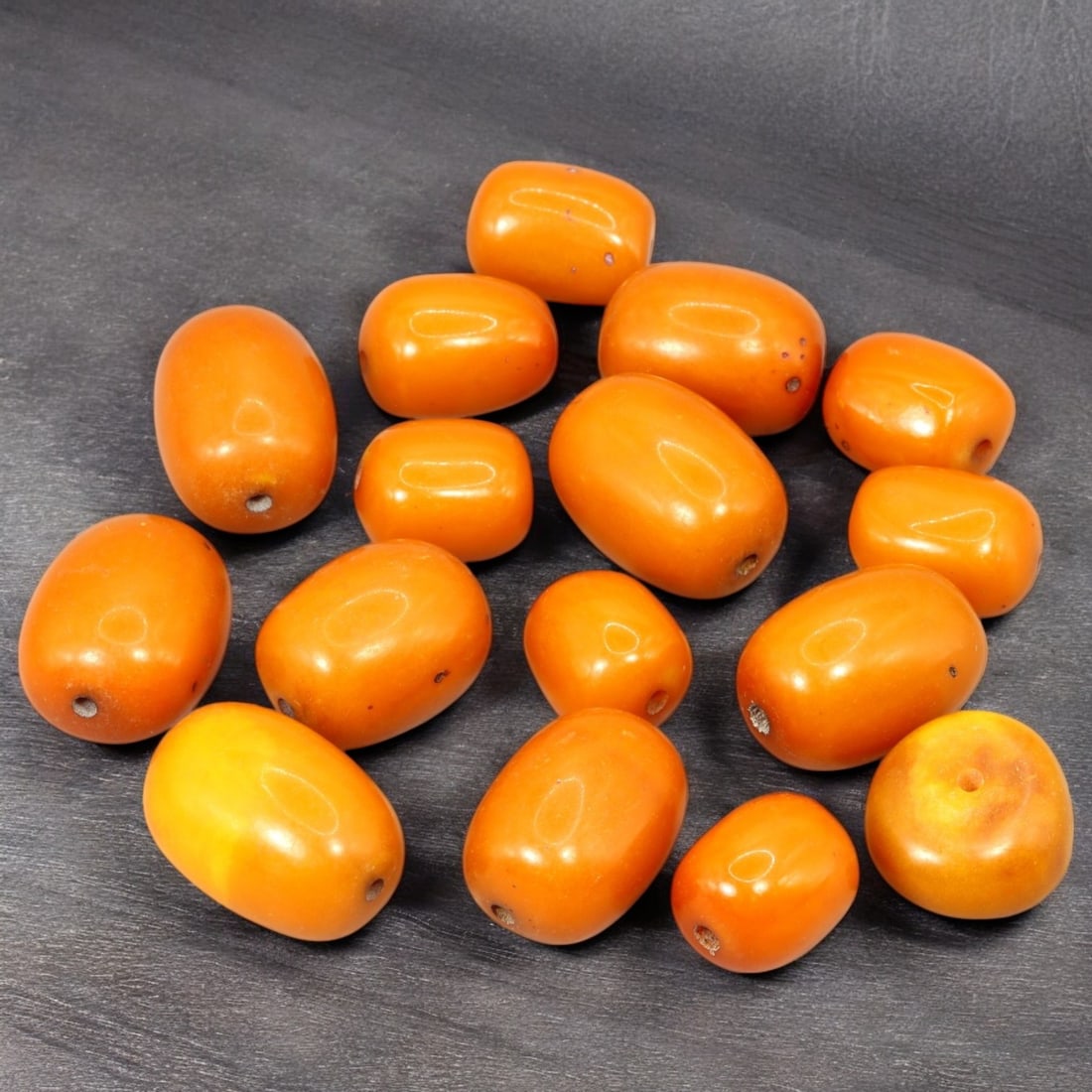 AFRICAN: Antique Amber Resin Beads, (73g, 2.5cm): This striking lot features African antique amber resin beads, weighing a total of 73 grams with individual beads measuring approximately 2.5cm in size. These warm-hued, barrel-shaped beads display a r