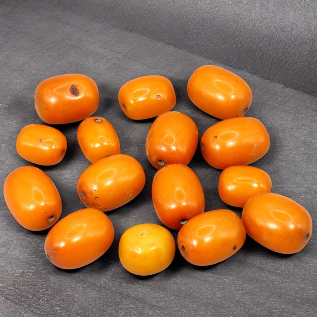 AFRICAN: Antique Amber Resin Beads, (73g, 2.5cm): This striking lot features African antique amber resin beads, weighing a total of 73 grams with individual beads measuring approximately 2.5cm in size. These warm-hued, barrel-shaped beads display a r