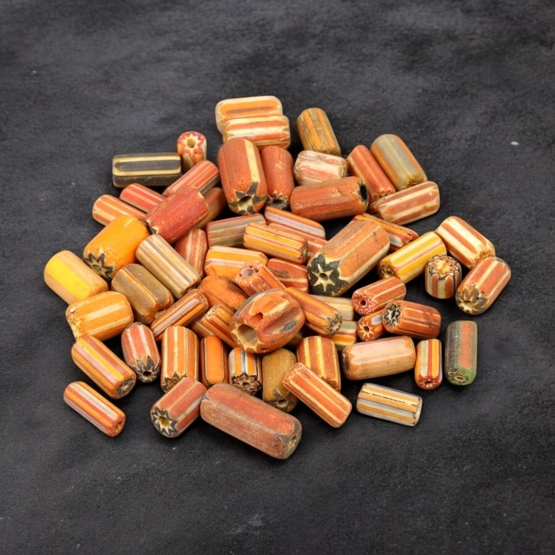 VENETIAN: Antique Millefiori Trade Beads, (43g, 1-2cm): This exceptional lot features Venetian antique millefiori trade beads, weighing a total of 43 grams with individual beads measuring between 1 and 2cm in size. These vibrant, cylindrical beads showcase