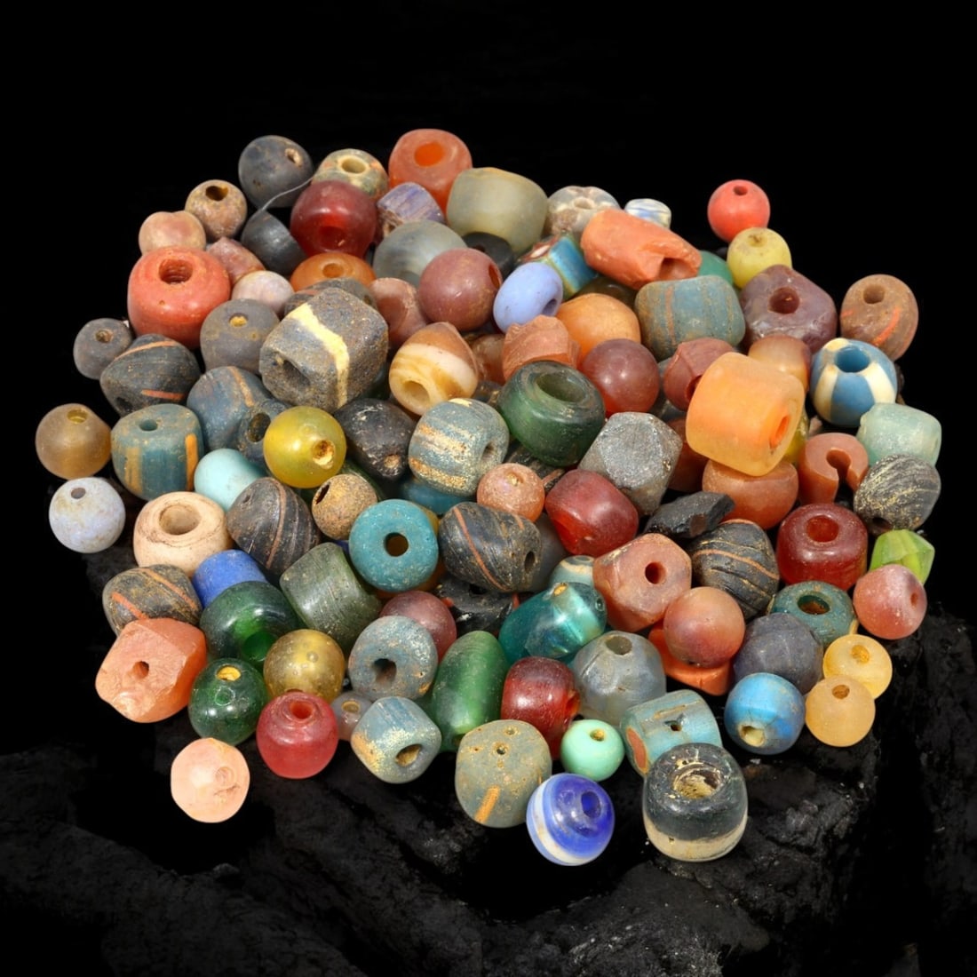 VENETIAN: Antique Millefiori Trade Beads, (63g, 1-2cm): This exceptional lot features Venetian antique millefiori trade beads, weighing a total of 63 grams with individual beads measuring between 1 and 2cm in size. These vibrant, cylindrical beads showcase