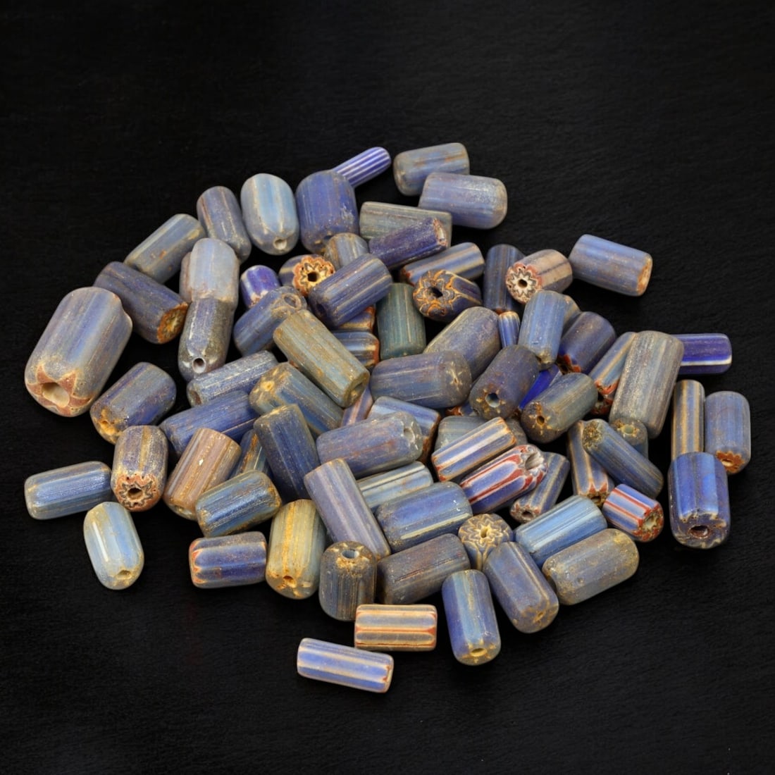 VENETIAN: Antique Millefiori Trade Beads, (46g, 1-2cm): This exceptional lot features Venetian antique millefiori trade beads, weighing a total of 46 grams with individual beads measuring between 1 and 2cm in size. These vibrant, cylindrical beads showcase