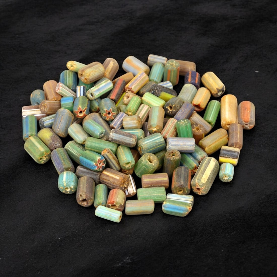 VENETIAN: Antique Millefiori Trade Beads, (72g, 1-2cm): This exceptional lot features Venetian antique millefiori trade beads, weighing a total of 72 grams with individual beads measuring between 1 and 2cm in size. These vibrant, cylindrical beads showcase