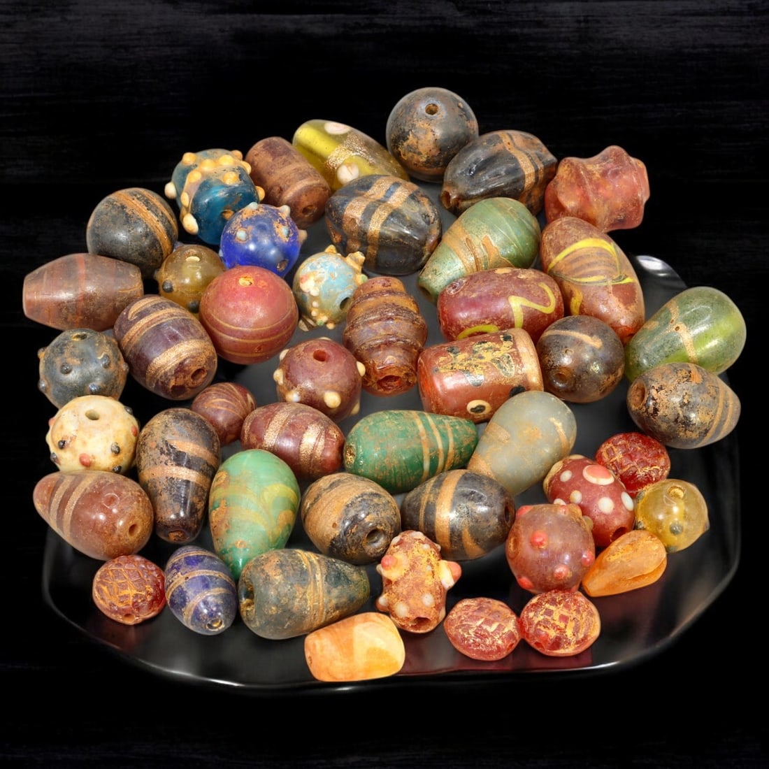 AFRICAN: Antique Mixed Polychrome Glass Trade Beads, (220g, 1-2.5cm): This vibrant lot features African antique mixed polychrome glass trade beads, with a total weight of 220 grams and individual bead sizes ranging from 1 to 2.5 cm. The collection showcases an array of