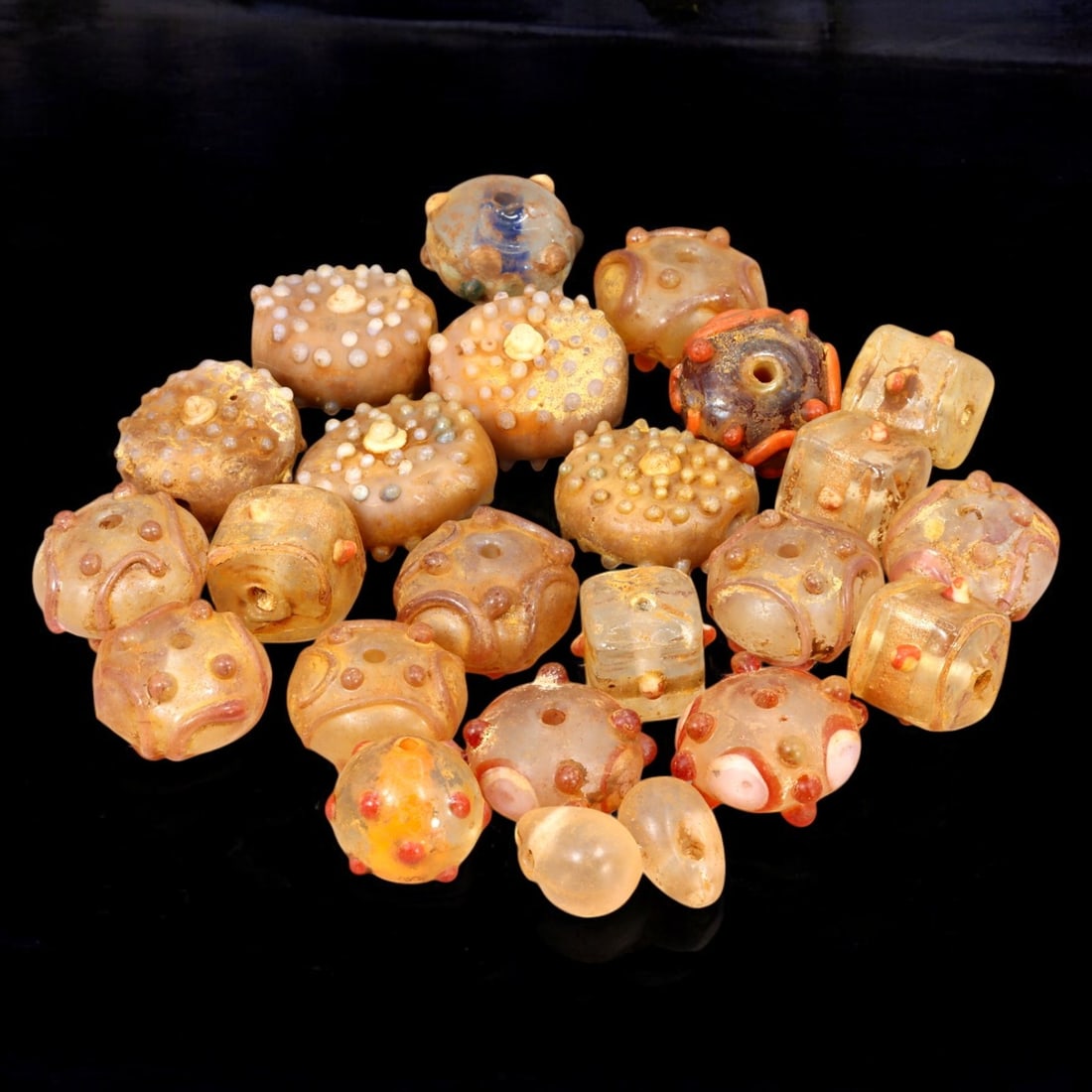 AFRICAN: Antique Polychrome Glass Trade Beads with Raised Dot Motifs, (118g, 1-2cm): This striking lot features African antique polychrome glass trade beads, with a total weight of 118 grams and individual bead sizes ranging from 1 to 2 cm. The collection showcases a variety of rounde