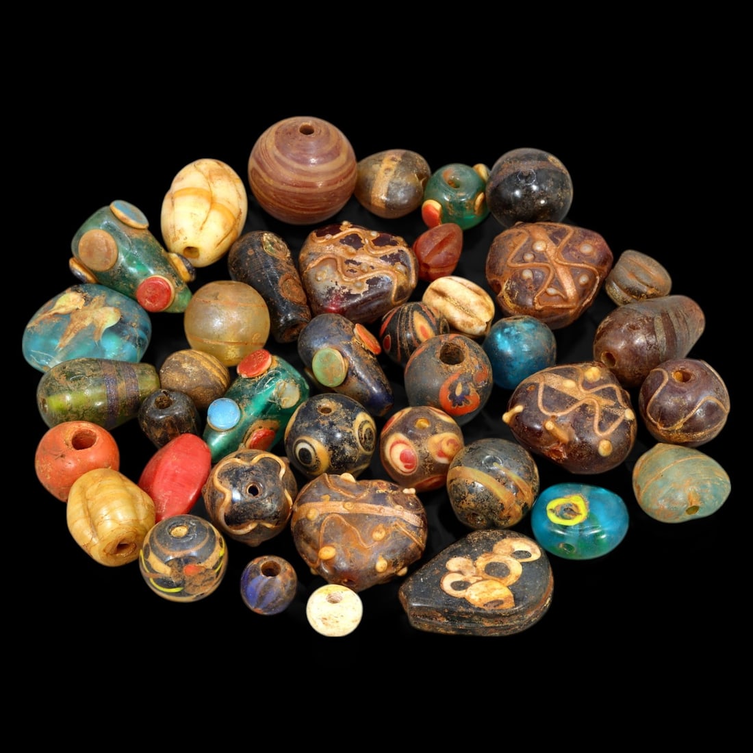 AFRICAN: Antique Mixed Polychrome Glass Trade Beads, (200g, 1-3cm): This vibrant lot features African antique mixed polychrome glass trade beads, with a total weight of 200 grams and individual bead sizes ranging from 1 to 3 cm. The collection showcases a diverse arra